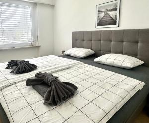 a bedroom with two beds with towels on them at Ferienwohnung C06 in Orselina +25 photos