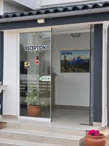 a door to a restaurant with a plant in the window at Villa Kreshta in Ksamil