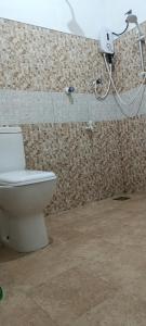 a bathroom with a toilet and a shower at MSM Surf Camp in Arugam Bay