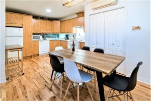 a kitchen with a wooden table and chairs at Charming Condo - Perfect for Visiting Quebec City in Quebec City