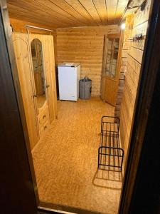 a room with a refrigerator and a chair in it at Hytta Kilpisjärvi in Kilpisjärvi +7 photos