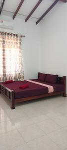 a bedroom with a large bed in a room at MSM Surf Camp in Arugam Bay +13 photos