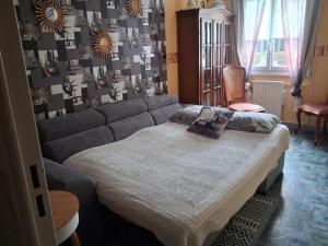 a living room with a bed and a couch at Chambre in Saint-Georges-du-Bois