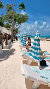 a group of lounge chairs on the beach at Coral Beach Hotel Punta Cana in Punta Cana +38 photos