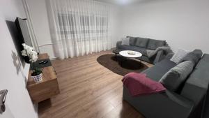 a living room with a couch and a table at Apartman Mešanović in Tuzla