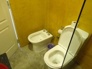 a small bathroom with a toilet and a bidet at Enjoy 360 in Villa Carlos Paz
