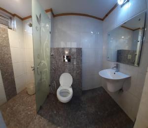 a bathroom with a toilet and a sink at Hotel Lords Regency - Connected to the Mall Road in Shimla +12 photos