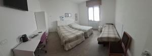 a hospital room with two beds and a desk at Casa Lilli in Zogno