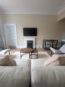 a living room with a couch and a fireplace at Modern Flat - Main St, Campbeltown in Campbeltown