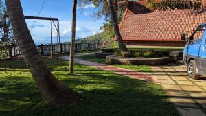 a car parked in a park with palm trees at Serenity peak cottage Ella in Badulla