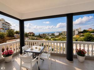 a balcony with a table and chairs and a view at Villa Kreshta in Ksamil