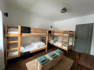 a room with three bunk beds and a table at Maison Elgenia in Saint-Martin-dʼArrossa +13 photos