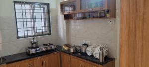a kitchen with a stove and a counter top at Elegant Beach View Flat , Bheemili in Bhīmunipatnam +16 photos