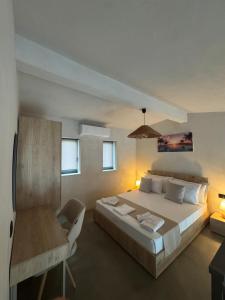 a bedroom with a large bed and a chair at Villa Roza 2 in Kallithea Halkidikis +17 photos