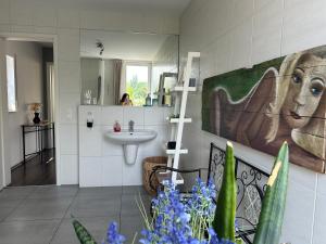 a bathroom with a sink and a mirror at House Susanne in Cologne +35 photos