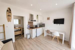a living room with a kitchen and a dining room at Studio la garrigue in Les-Pennes-Mirabeau