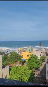 a view of a city with the ocean in the background at Elegant Beach View Flat , Bheemili in Bhīmunipatnam