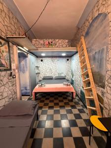 a room with a bed and a ladder in it at Kandinsky CASA VACANZE Relax in Monterosso Almo
