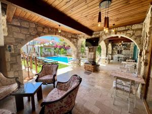 a living room with an archway and a pool at Windmill Alaçatı in Alaçatı