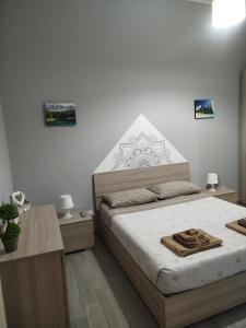 a bedroom with a large bed in a room at CAMARDA HOME in Bernalda