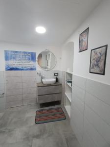 a bathroom with a sink and a mirror at Kandinsky CASA VACANZE Relax in Monterosso Almo +19 photos