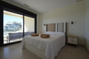 a bedroom with a large bed and a large window at Ocean Homes, Vista Mar y piscina EXCELLENT & SOLMARES in Punta del Caimán +32 photos