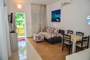 a living room with a couch and a table at Apartments Paradise in Ulcinj