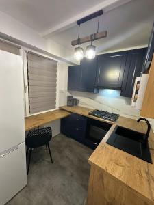 a kitchen with blue cabinets and a counter top at Apartament Blue Velvet in Skierniewice