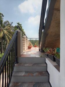 a staircase leading up to a house with potted plants at The Sun Horse Villa in Unawatuna