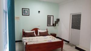 a bedroom with a bed in a room at The Sun Horse Villa in Unawatuna