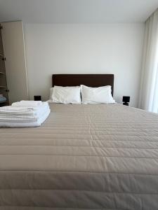 a large white bed with white sheets and pillows at AFIFE T1D Bouça Cabrita Residences in Afife