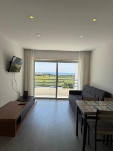 a living room with a couch and a table at AFIFE T1D Bouça Cabrita Residences in Afife