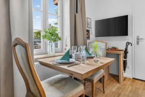 a dining room with a wooden table and chairs at Design Mini Studio No 9, Küche, Parkplatz, Wifi by BALANCED in Holzkirchen