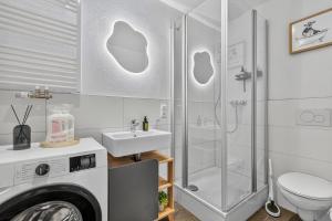 a bathroom with a shower and a toilet and a sink at Design Mini Studio No 9, Küche, Parkplatz, Wifi by BALANCED in Holzkirchen