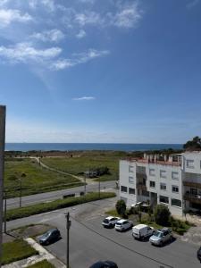 a view of a parking lot with cars parked in front of a building at AFIFE T1D Bouça Cabrita Residences in Afife