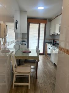 a kitchen with a table and chairs in a room at La Nala in Villaviciosa