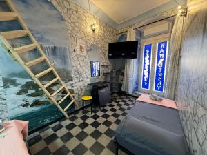 a room with a bed and a tv and a staircase at Kandinsky CASA VACANZE Relax in Monterosso Almo