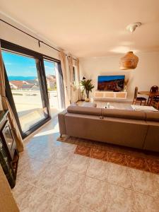 a living room with a couch and a large window at Casa Milano Krk in Njivice +73 photos