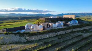 a group of observatories on a hill in a field at Wine Bubble in Cuzcurrita-Río Tirón +38 photos