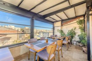 a room with tables and chairs and a large window at Rocca Stone House in Göreme