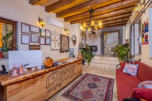 a lobby with a reception desk and a couch at Rocca Stone House in Göreme