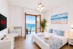 a bedroom with a bed and a view of the ocean at You and the Sea in Savona