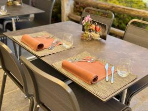 a table with napkins and utensils on top at Hotel Stüa Granda in Soglio