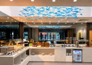 a restaurant with a blue chandelier above a counter at Eurotraveller Hotel - Premier - Tower Bridge in London