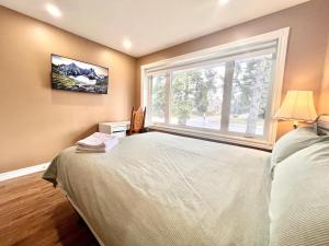 a bedroom with a bed and a large window at Renovated Rooms 10-min to Finch Subway Near Yonge St in Toronto