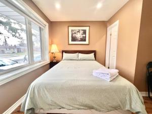 a bedroom with a bed and a window at Renovated Rooms 10-min to Finch Subway Near Yonge St in Toronto