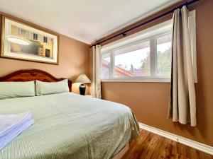 a bedroom with a bed and a window at Renovated Rooms 10-min to Finch Subway Near Yonge St in Toronto +11 photos