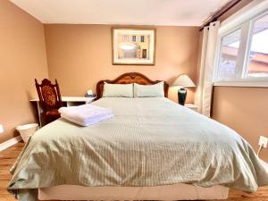 a bedroom with a large bed and a window at Renovated Rooms 10-min to Finch Subway Near Yonge St in Toronto