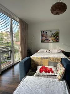 a bedroom with two beds and a blue couch at House Susanne in Cologne