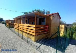 a small wooden house is behind a fence at Top Village in Cogoleto +22 photos